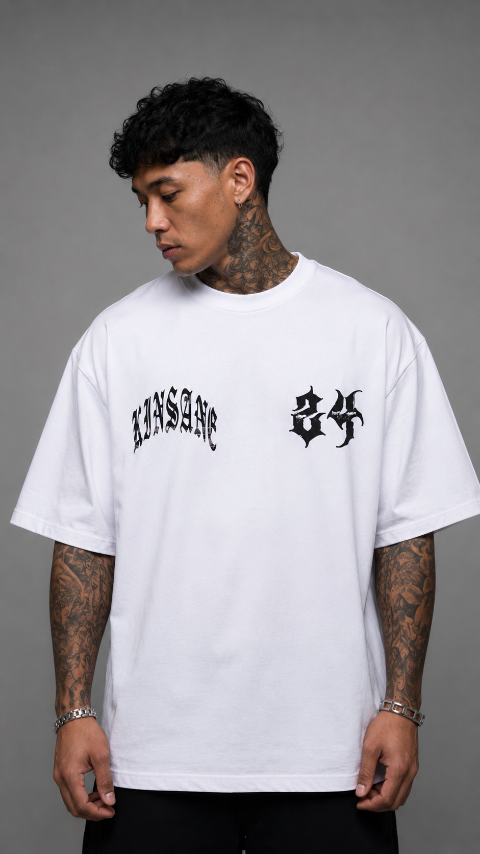 Man wearing White t shirt with black text reading “KINSANE” and “24” 