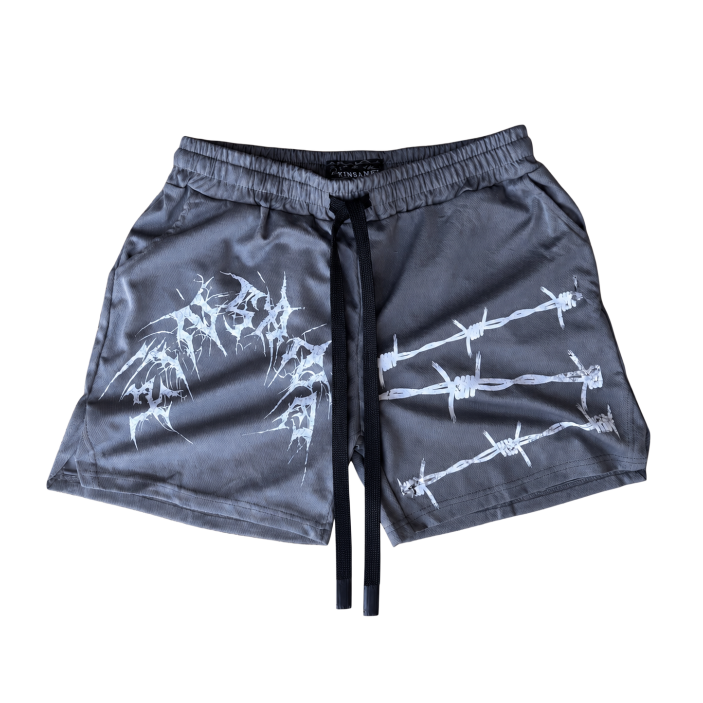 gray athletic shorts with black drawstrings and white text reading “KINSANE” on the left side and white barbed wire design on the right side 
