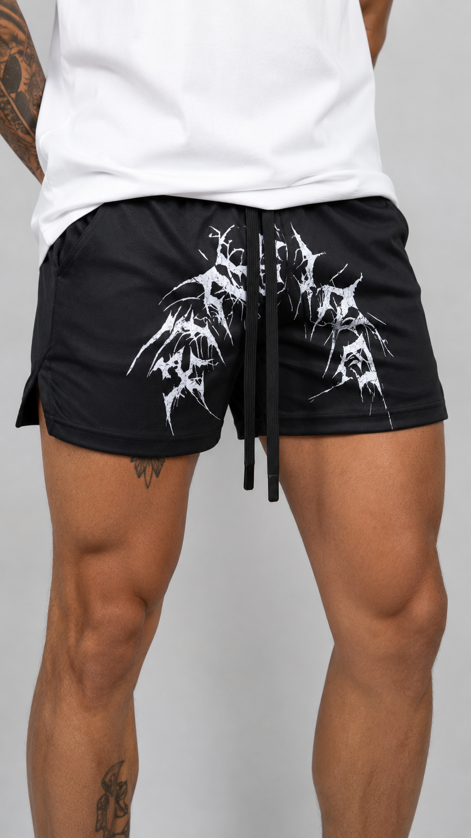 Man wearing Black athletic shirts with elastic waistband and black drawstrings with white tribal lettering reading “KINSANE” across the middle 