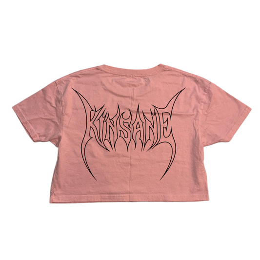 Back view of a pink crop top T-shirt with black tribal outlined lettering reading “KINSANE” 