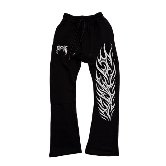 Black stacked sweatpants with white tribal lettering reading “KINSANE” on the left side and white tribal flames on the right side 