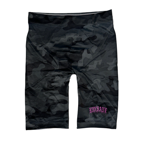 Black and grey camo compression shorts with pink old English style lettering reading “KINSANE” on the right side 