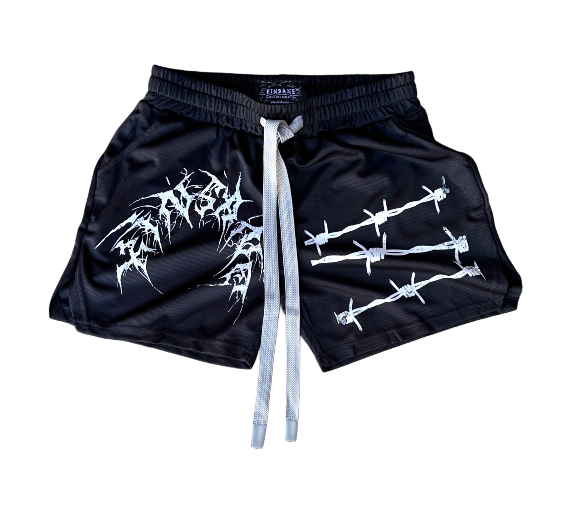 Black athletic shorts with elastic waistband and gray drawstrings and white tribal lettering reading “KINSANE” on the right leg and white barbed wire design on the left leg 