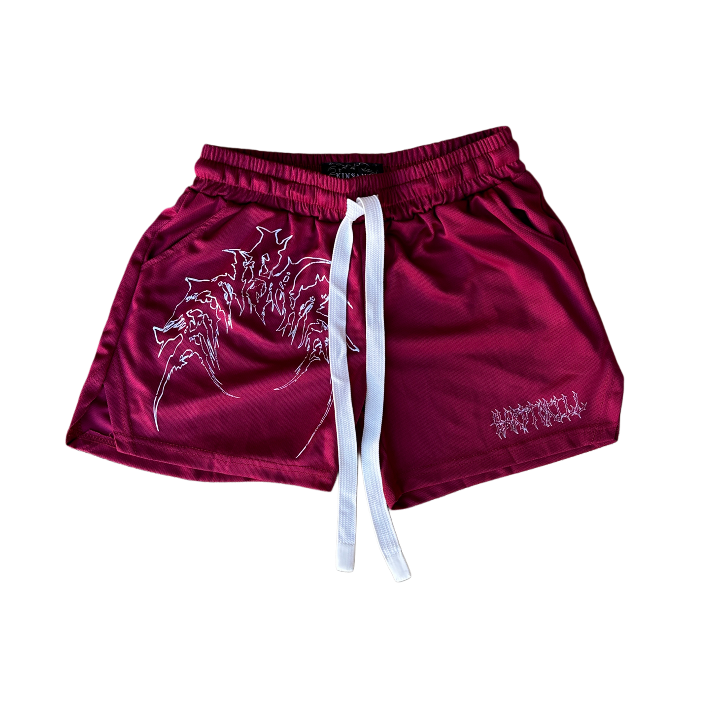 Dark red athletic shorts with elastic waistband and white drawstrings with white outlined tribal lettering reading “KINSANE” on the right leg and white tribal outlined lettering reading “HARDTOKILL” on the left leg