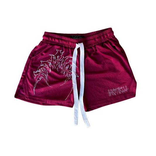 Dark red athletic shorts with elastic waistband and white drawstrings with white outlined tribal lettering reading “KINSANE” on the right leg and white tribal outlined lettering reading “HARDTOKILL” on the left leg