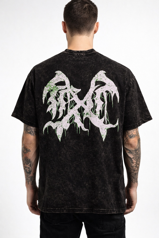 Back view of a man wearing a black acid washed t-shirt with a white and green logo 