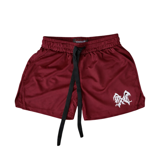 Maroon athletic shorts with black drawstrings and white logo on the left leg 