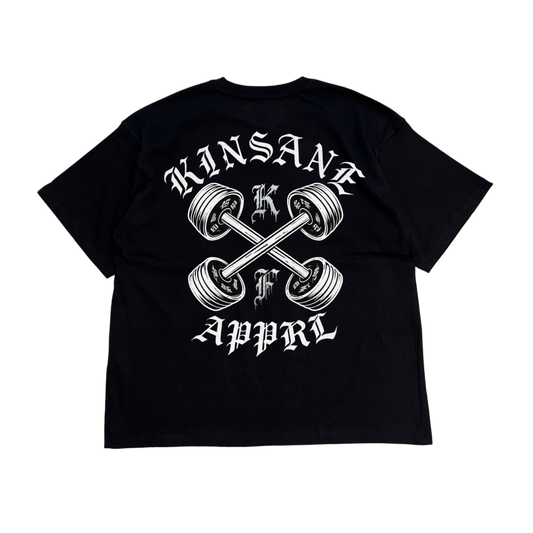 Back view of a black t shirt with a white weights crossing logo with white lettering reading “KINSANE APPRL” and silver lettering single letters “K” and “F”