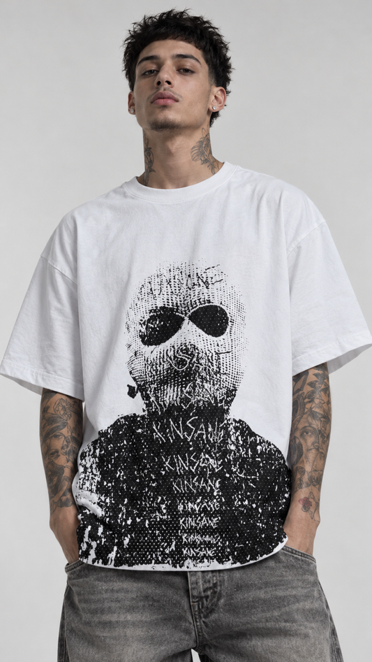 Man wearing White t shirt with gray and black design of a man wearing a ski mask with “kinsane” scratched on it 