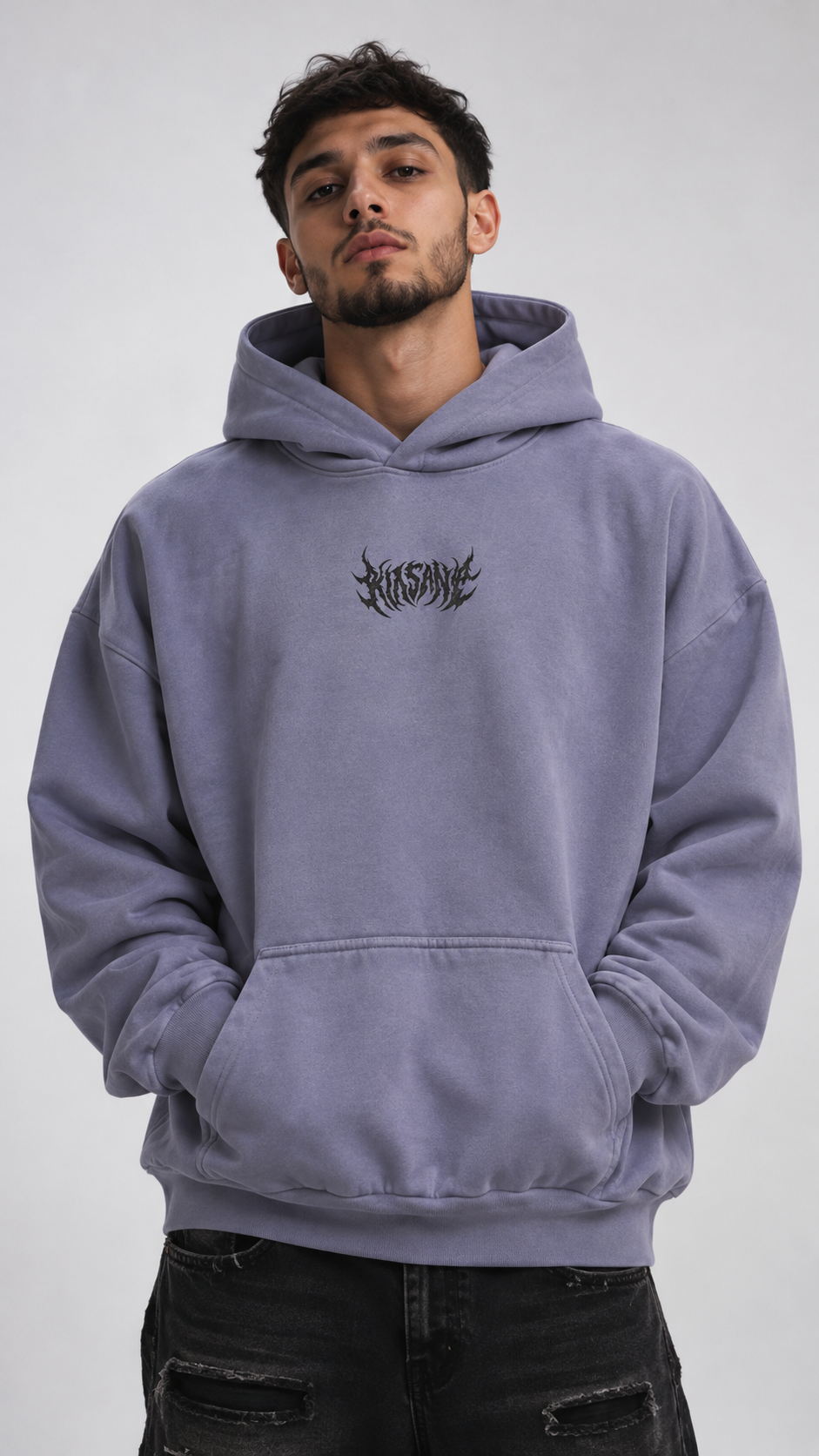 Man wearing a Light blue hoodie with black text in the center reading “KINSANE” 