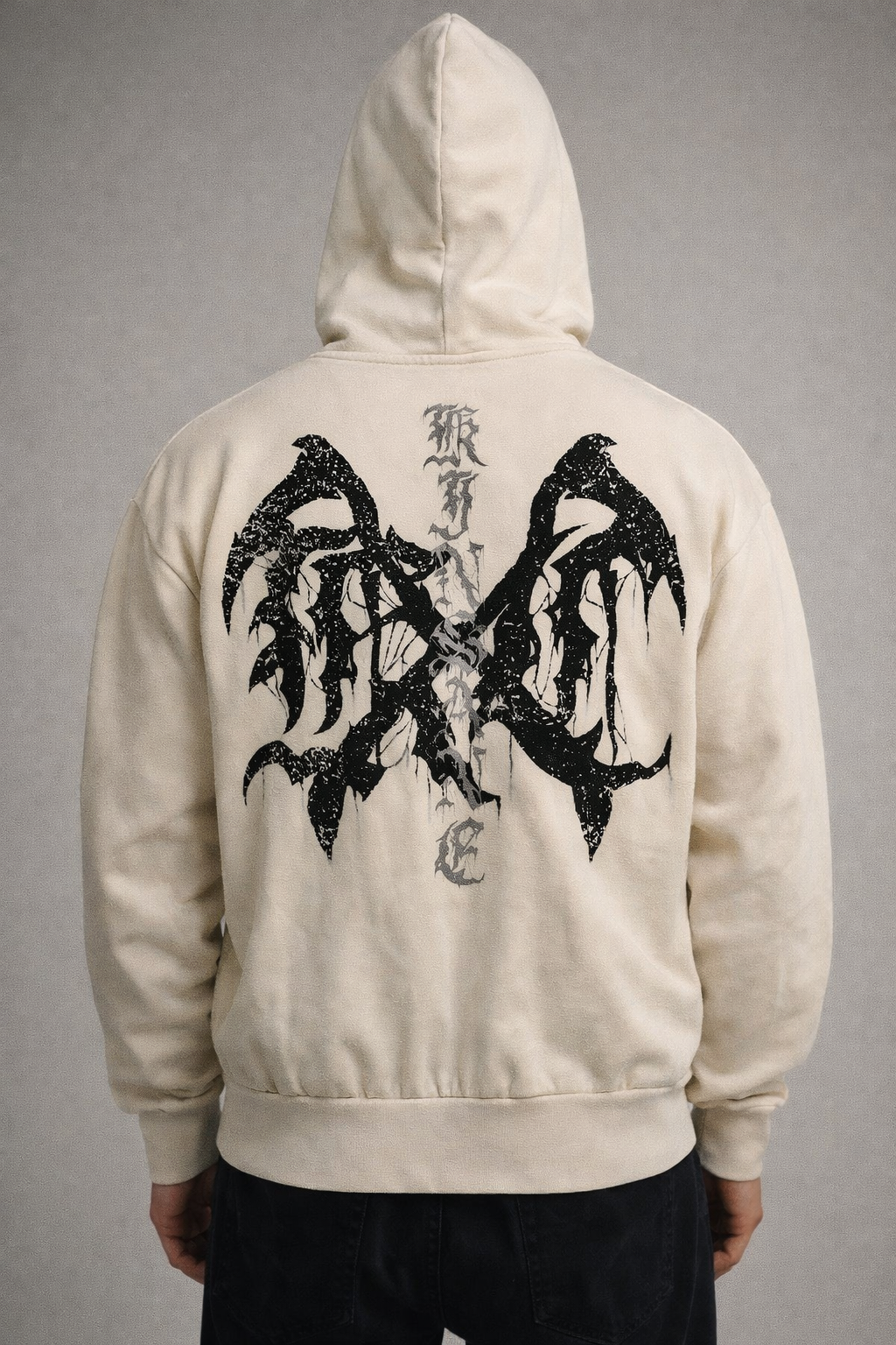 Back view of a man wearing a tan hoodie with black logo and silver lettering reading “KINSANE” 