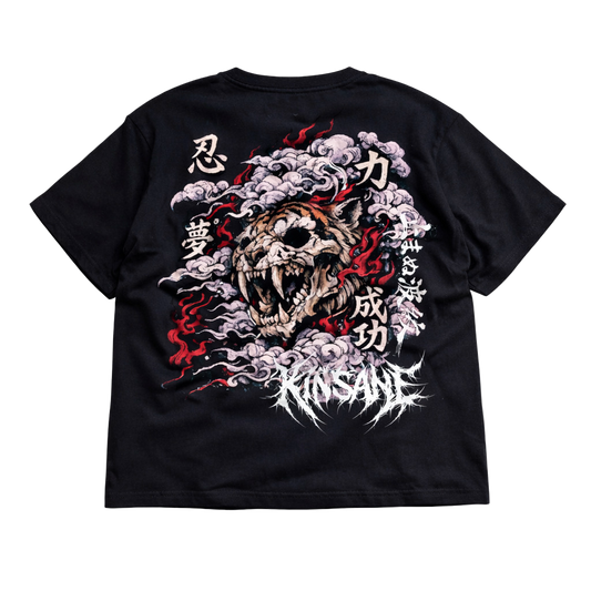 Back view of a black T-shirt with a tiger skull design surrounded by red flames and white Japanese style smoke and Japanese text and white text reading “KINSANE” 