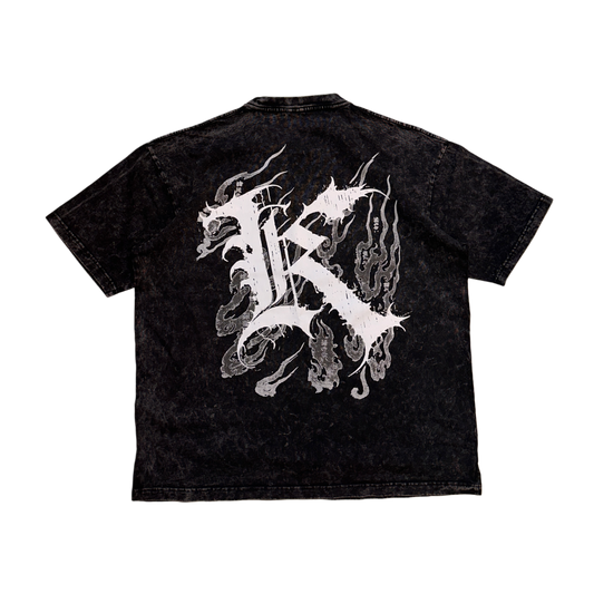 Back view of a acid washed black T-shirt with a white logo displaying white Japanese style flames and a white letter “K” and various Japanese text 