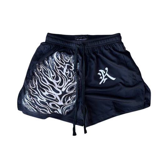 Black athletic shorts with black drawstrings and a white flames design on the right leg and a white logo in the letter of “K” on the left leg 