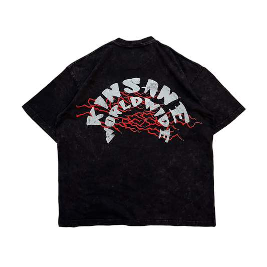 Back view of a black acid washed t shirt with red lightning behind white text reading “KINSANE WORLDWIDE” 