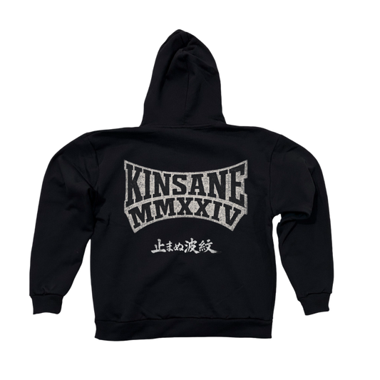 Back view of a black hoodie with black lettering reading “KINSANE MMXXIV” and white outlining and also white Japanese text 