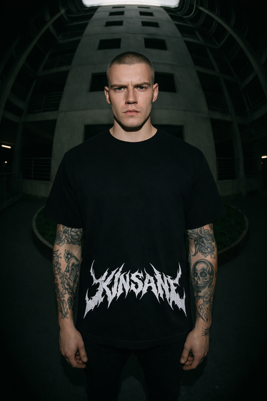 Man wearing a Black t shirt with white text reading “KINSANE” 