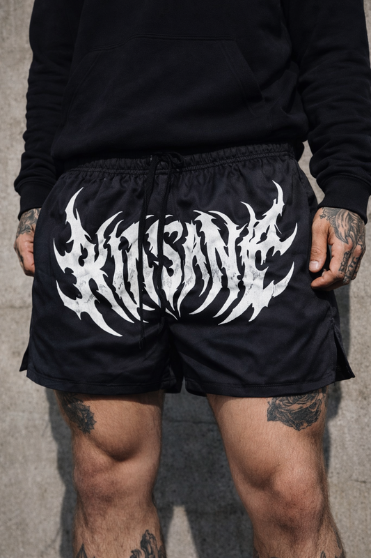 Man wearing Black athletic shorts with black drawstrings with white text reading “KINSANE” 