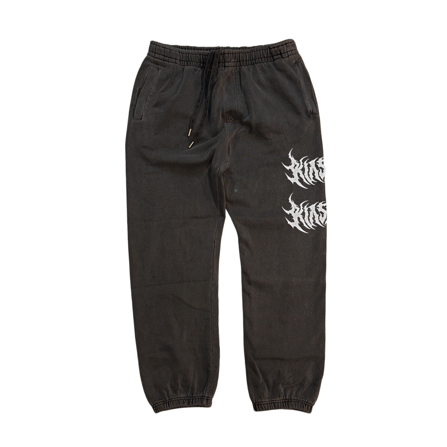 Vintage grey cuffed joggers with white text reading “KIN” on the front left leg