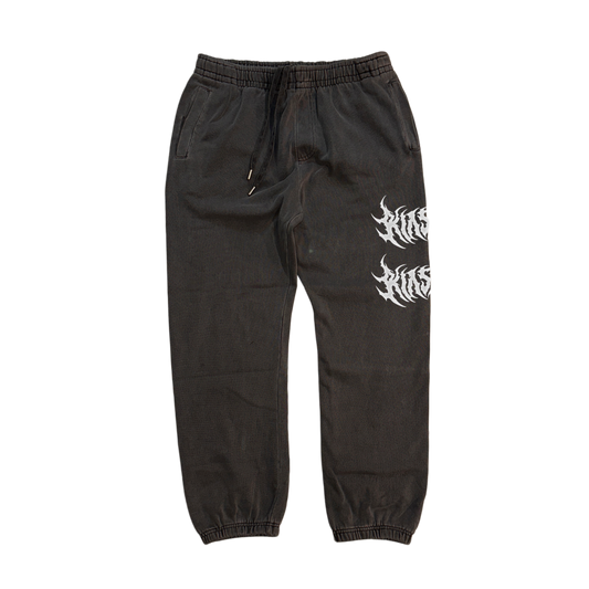 Vintage grey cuffed joggers with white text reading “KIN” on the front left leg